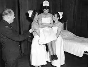 Lifting Prints: Student nurses practising three handed lift