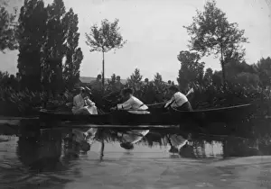 Three students rowing