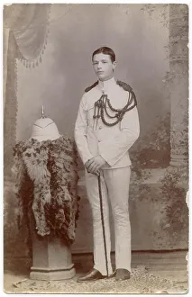 Studio photo, young soldier in white uniform, left shoulder aiguillette and white spiked sun helmet, Far East Date: circa 1910