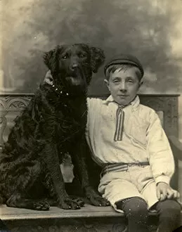 Images Dated 27th May 2016: Studio portrait, boy with large black dog