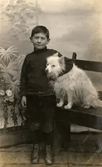 Studio portrait, boy with white dog