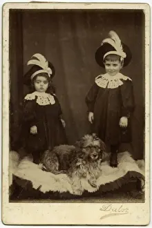 Studio portrait, two children with dog