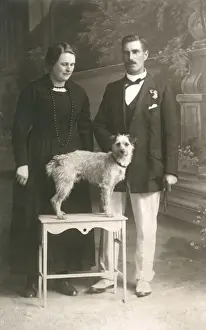 Studio portrait, couple with dog