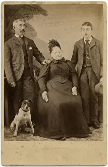 Studio portrait, family of three with terrier dog