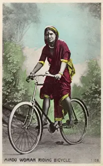 Handlebars Prints: Studio portrait, Hindu woman riding a bicycle, India