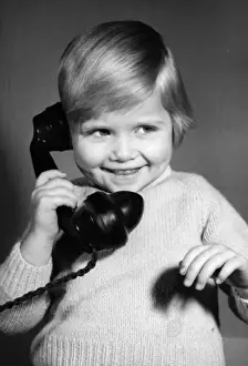 Studio portrait, little boy on the phone
