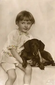 Studio portrait, little child with dachshund