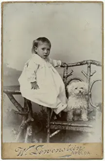 Studio portrait, little child with dog
