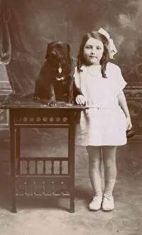 Studio portrait, little girl with her dog