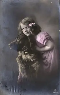 Studio portrait, little girl with large dog