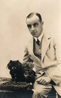 Studio portrait, man with Pekingese dog, France