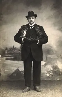 Pekingese Prints: Studio portrait, man with two Pekingese dogs