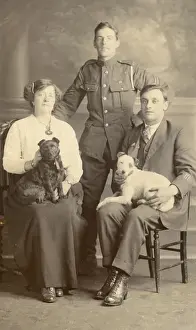 Studio portrait, three people with two dogs