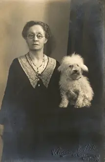 Studio portrait, woman with little white dog