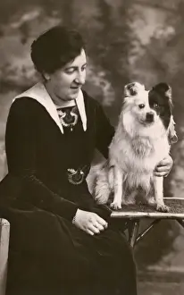 Studio portrait, woman with Pomeranian dog