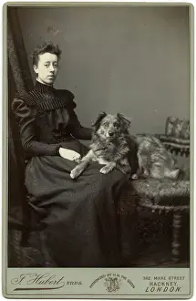 Studio portrait, young woman with dog