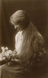 Images Dated 31st March 2017: Studio portrait, young woman with long hair and flowers