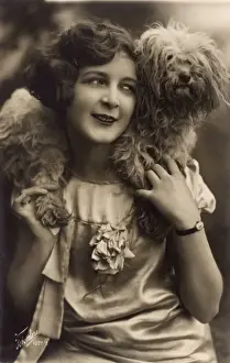 Studio portrait, young woman with terrier dog