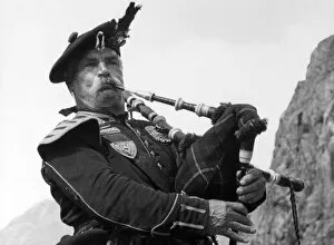 Bagpipes Gallery: Study of Highland Piper, playing his bagpipes, Scotland. Date: 1950s