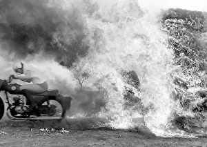 Stunt woman rides through flames on motorbike