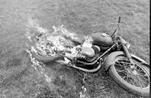Stunt woman rides through flames on motorbike