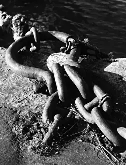 A sturdy chain tie-ring for mooring boats at a quayside. Date: 1950s
