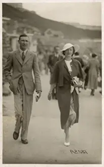 Stylish holiday couple in Scarborough walk along the beach