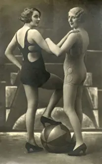 Daring Prints: Two stylish Swimwear models posing with a beach ball