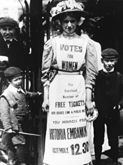 A suffragette advertising a votes for women march