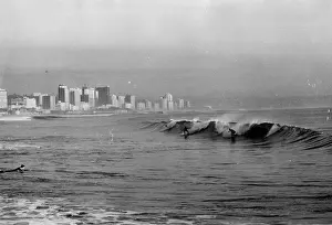Surfing at Durban, South Africa. Date: late 1960s
