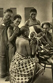 Swahili women dressing each others hair, East Africa