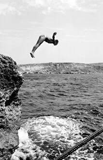 Swimmer diving into the sea off the coast of Malta