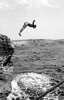 Swimmer diving into the sea off the coast of Malta Swimmer diving into the sea off the coast of Malta