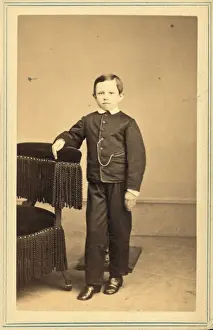 Tad Lincoln, standing, leaning against a chair