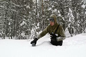 Males Collection: Taking a snow depth measurement - boreal forest