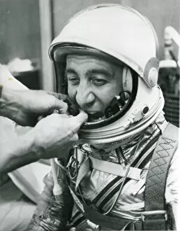 Virgil Gallery: A technician adjusts the microphones for astronaut Virg?