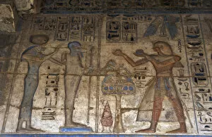 Temple of Ramses III. The pharaoh making offerings before go