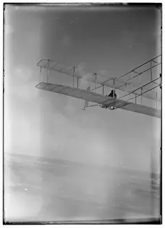 Wilbur Prints: Three-quarter left rear view of glider in flight at Kitty Ha