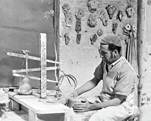 Throwing a pot on a wheel in a pottery factory