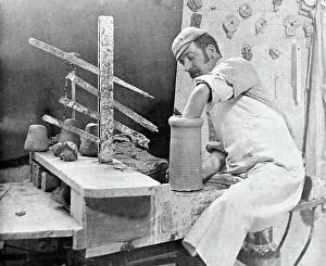 Throwing a pot on a wheel in a pottery factory