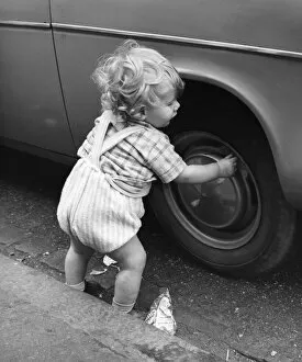 Toddler playing with car tyre, Balham, SW London