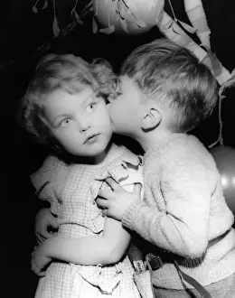 Two toddlers under the mistletoe