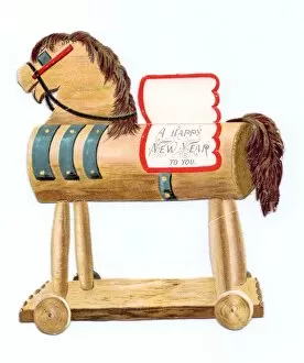 Toy horse on wheels on a cutout New Year card