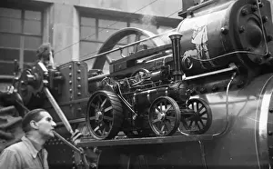 Newhall Prints: Traction engine model on running board of a full size engine
