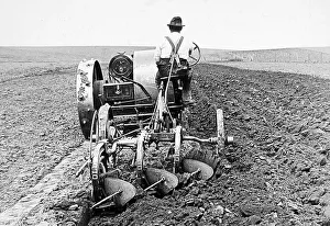 Plowing Prints: Tractor plowing South Dakota USA early 1900s