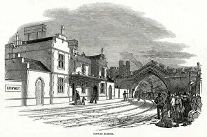 Train passing under arch into Conway railway station 1848