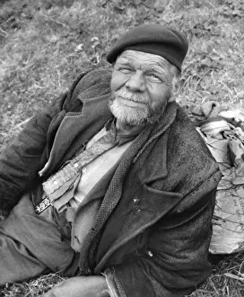 Overcoat Prints: Tramp sitting on grass, Balham, SW London