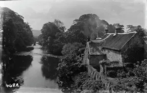 Tranquil River Scene with Thatched Cottage