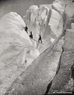 Glacier Gallery: Traversing a crevasse, climbers in the Alps
