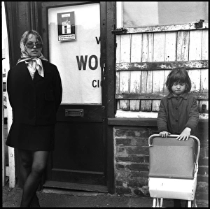Images Dated 6th October 2015: Trendy young mum with daughter and toy pram early